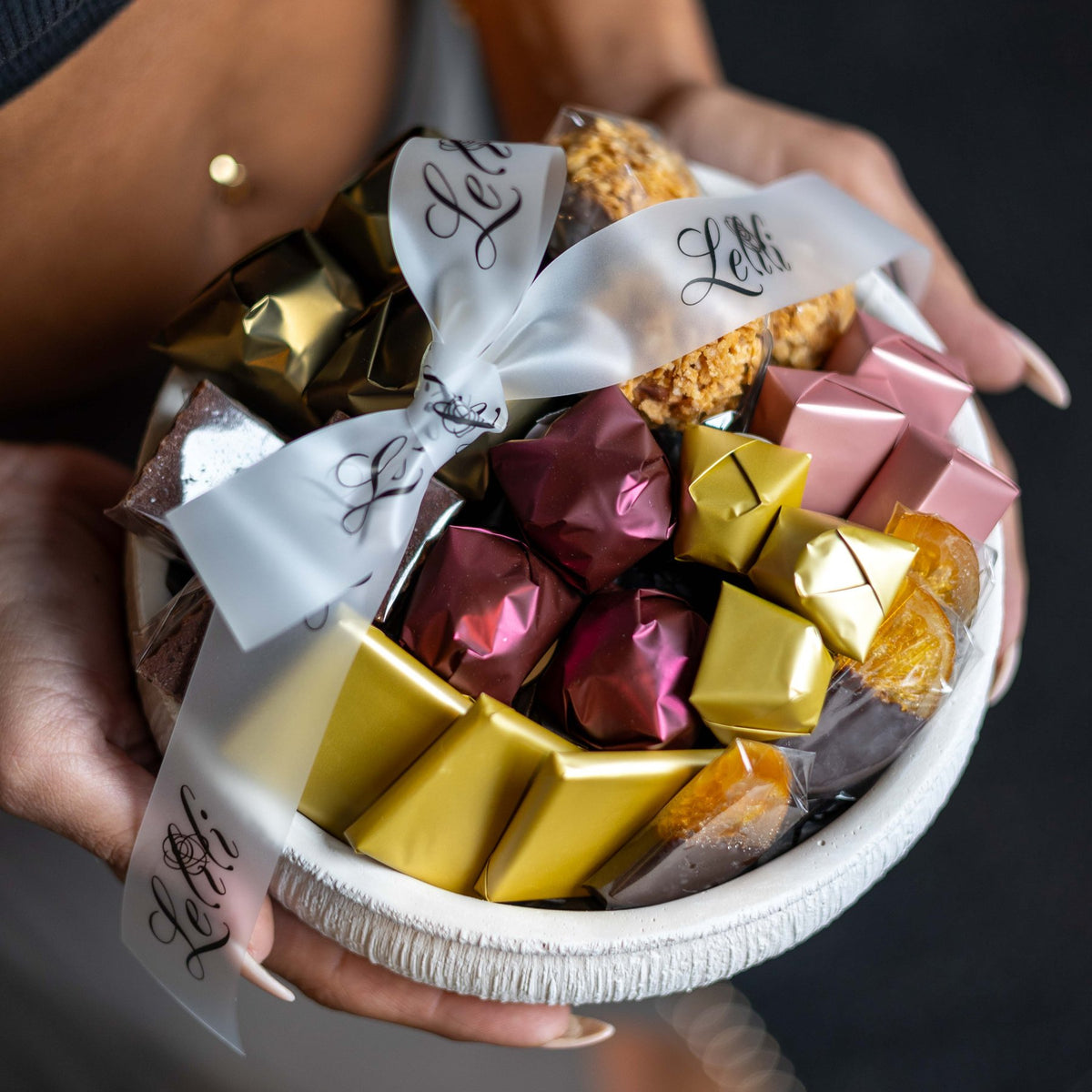 The Ivory Ribbed Bowl, the MEDIUM size, top view of the chocolate arrangement