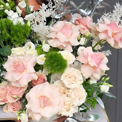 Souffle de rose, close view of the blush garden roses and green dianthus